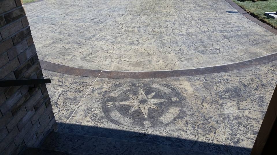 Close-up of compass rose inlay on stamped concrete driveway