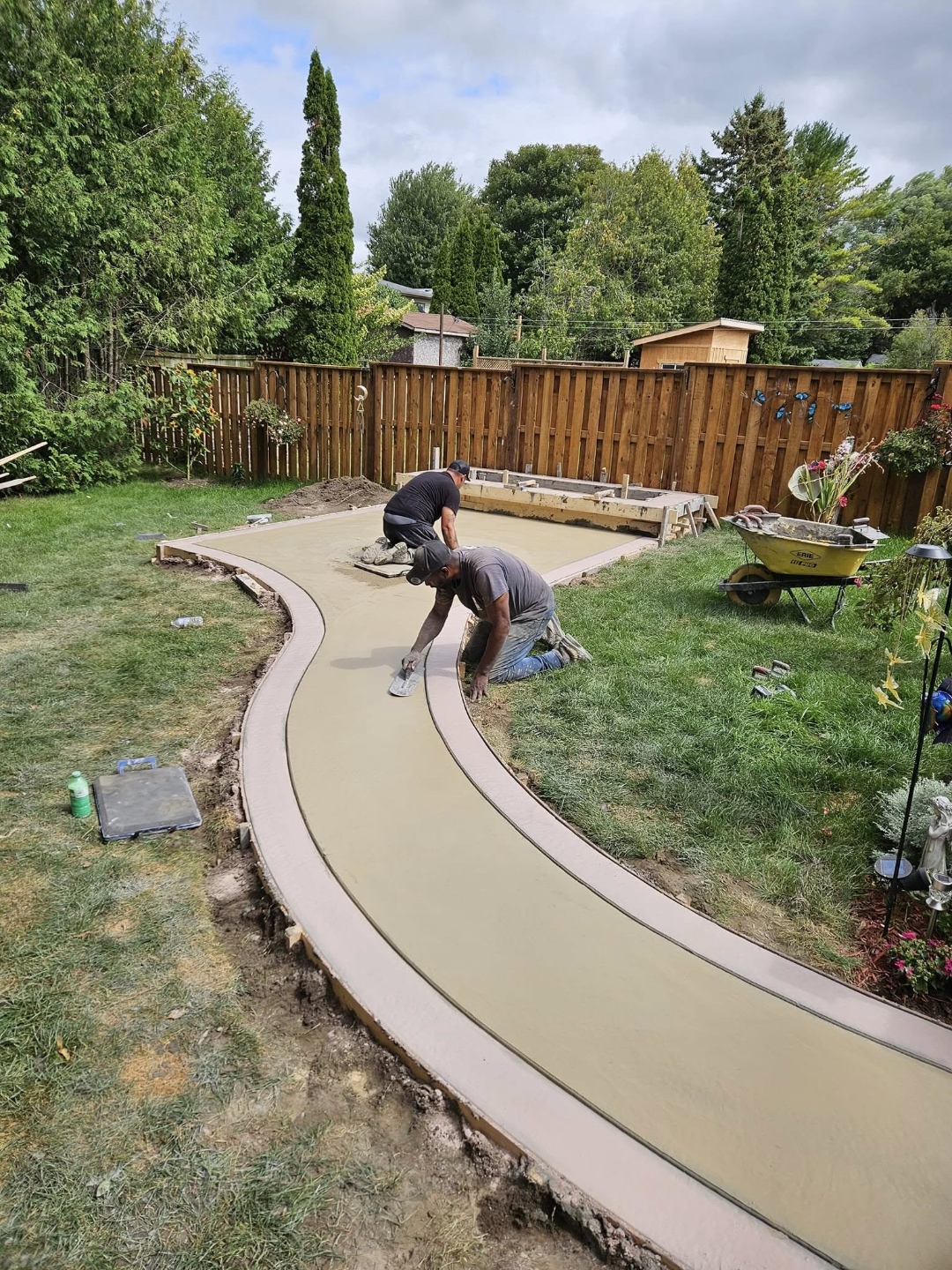 Crew pouring and finishing curved concrete path — Wice Concrete in action