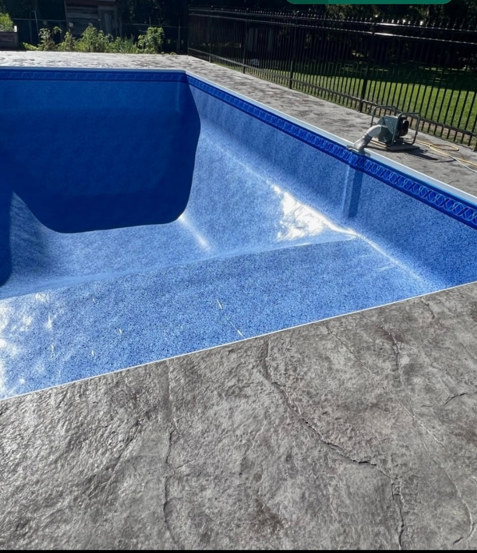 Stamped concrete pool deck edge with blue pool liner