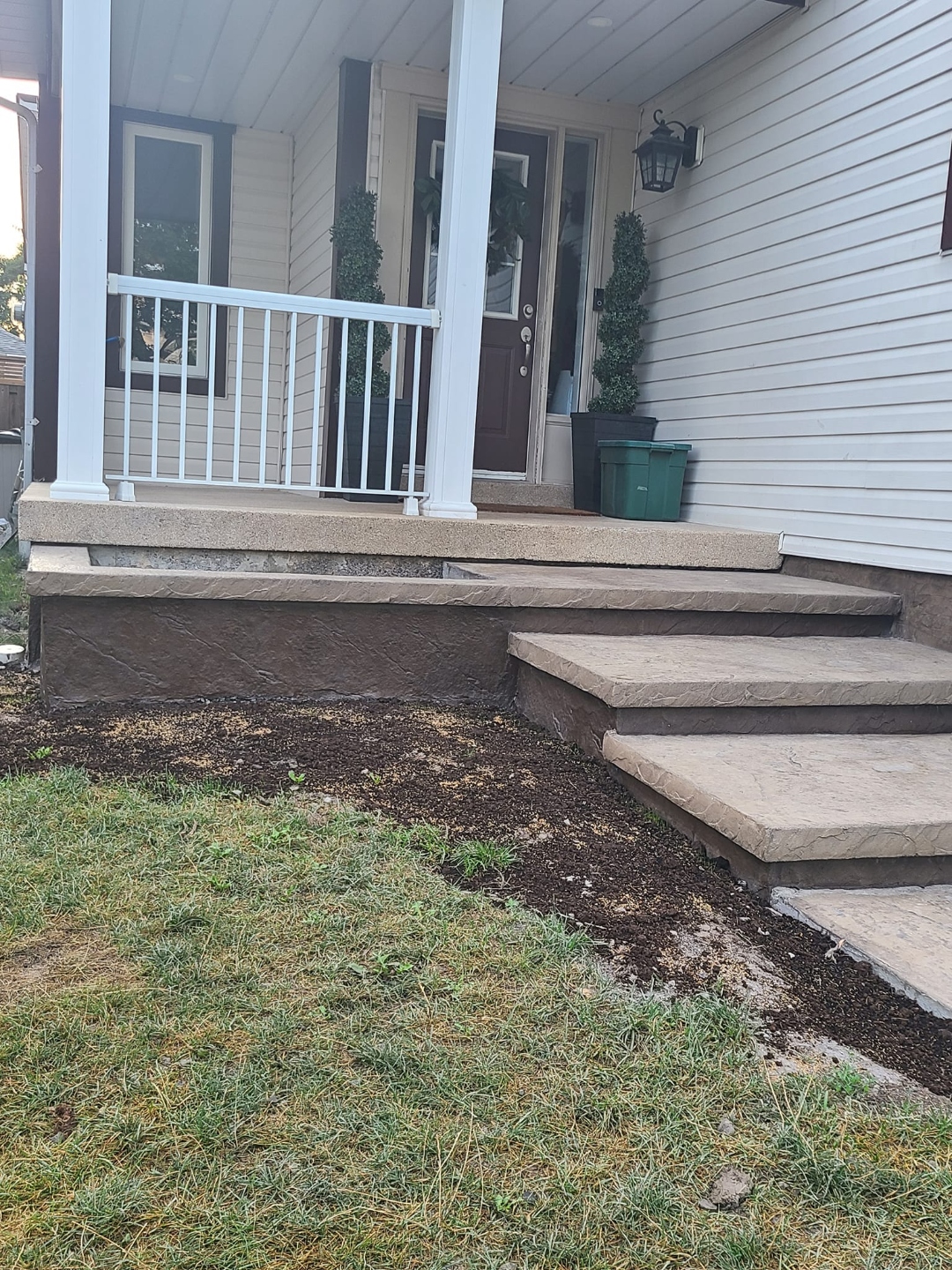 Stamped concrete front porch steps and landing in tan and brown tones