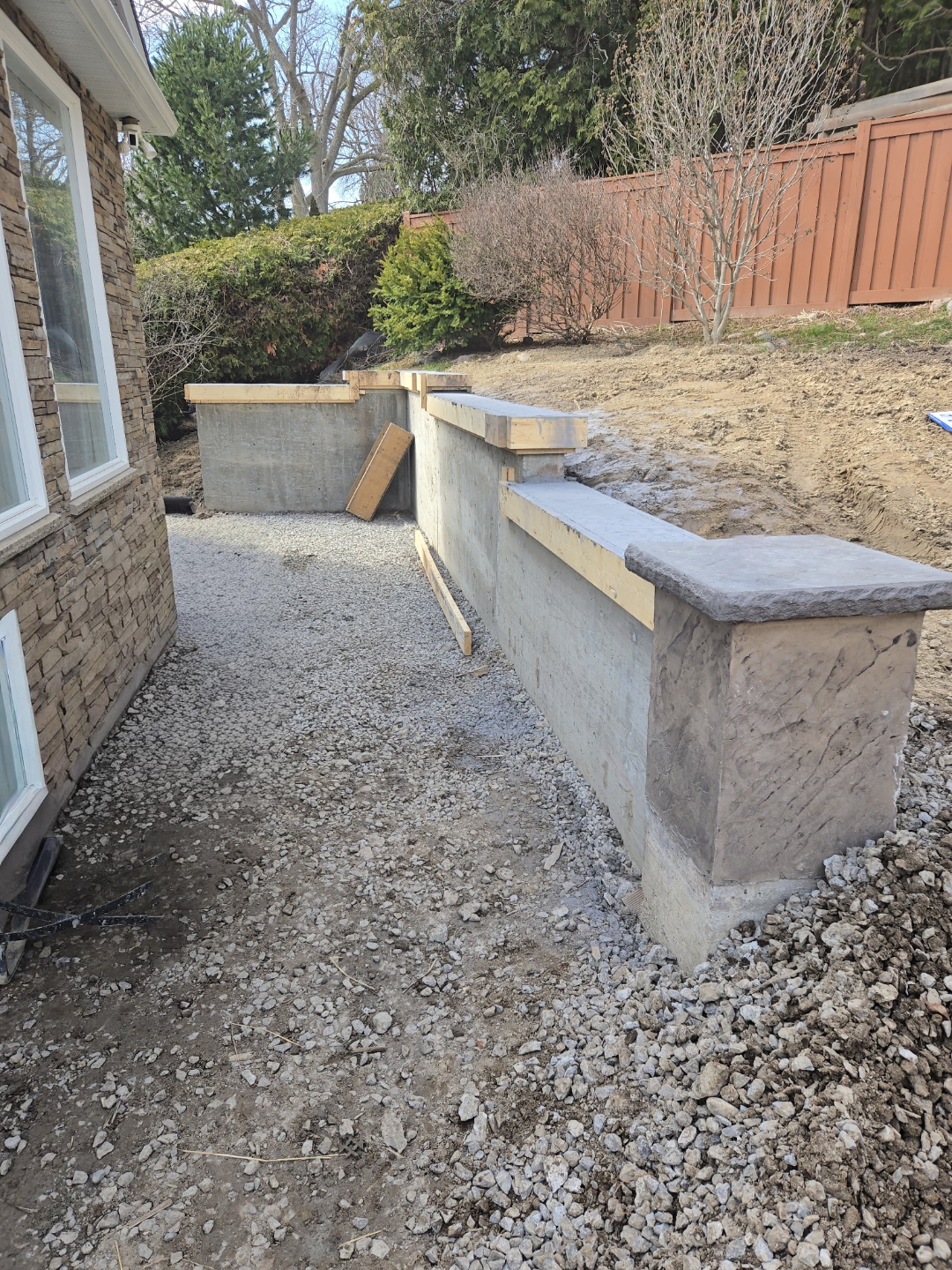 Concrete retaining wall with stamped cap, side view