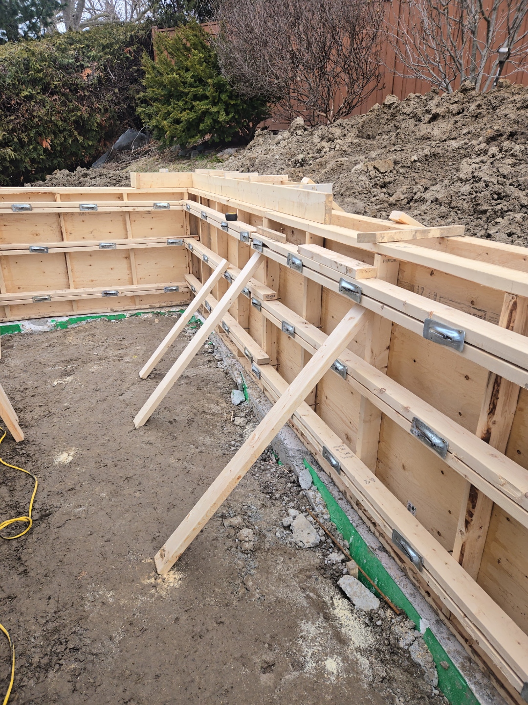 L-shaped retaining wall formwork under construction