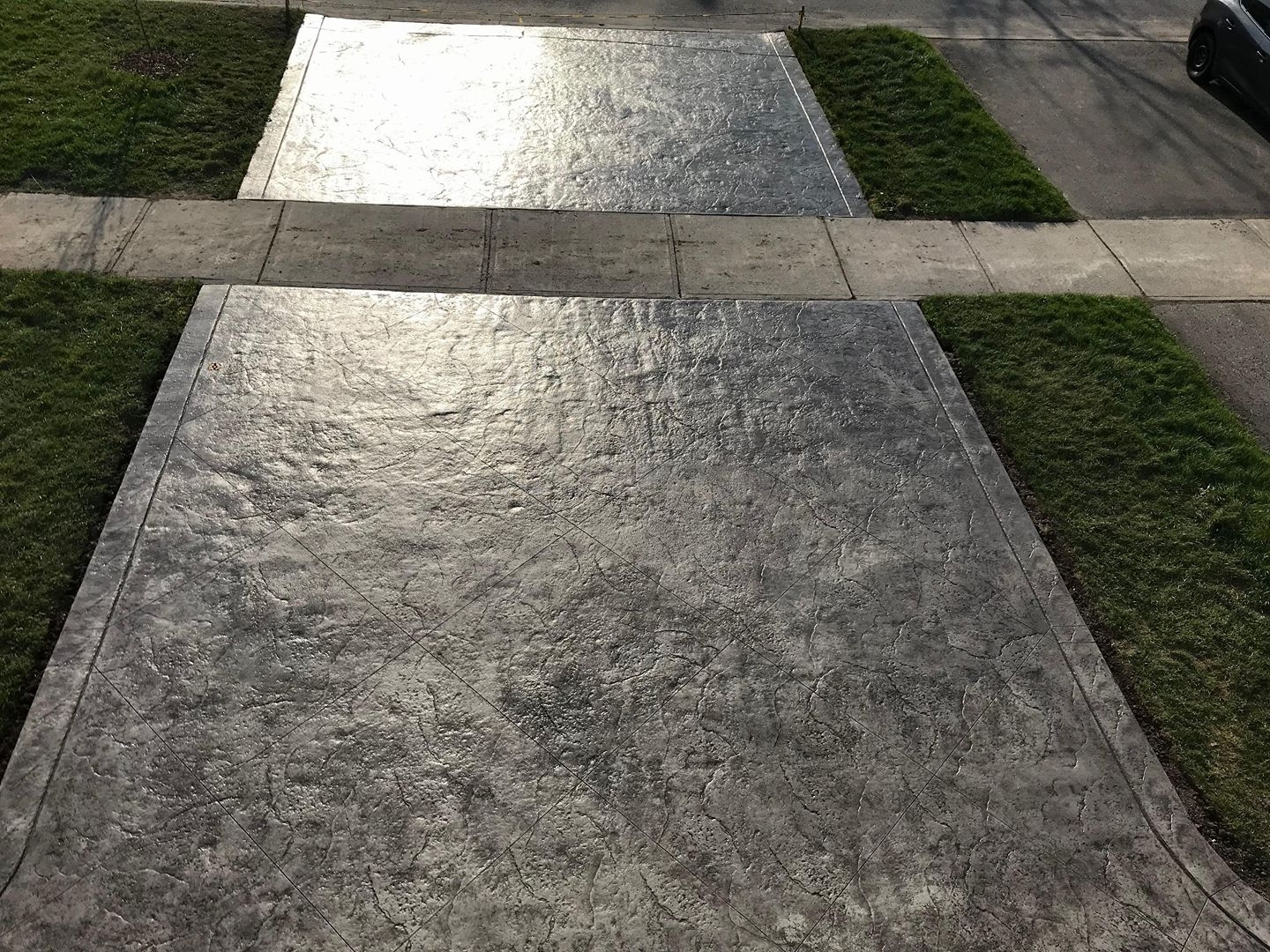 Two stamped concrete driveway apron slabs from elevated view