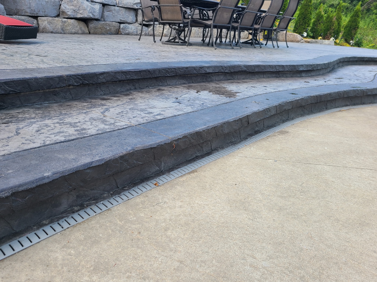 Curved stamped concrete steps leading to pool patio
