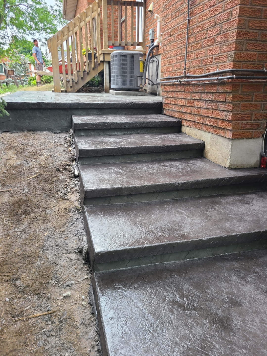 Dark charcoal stamped concrete side stairs