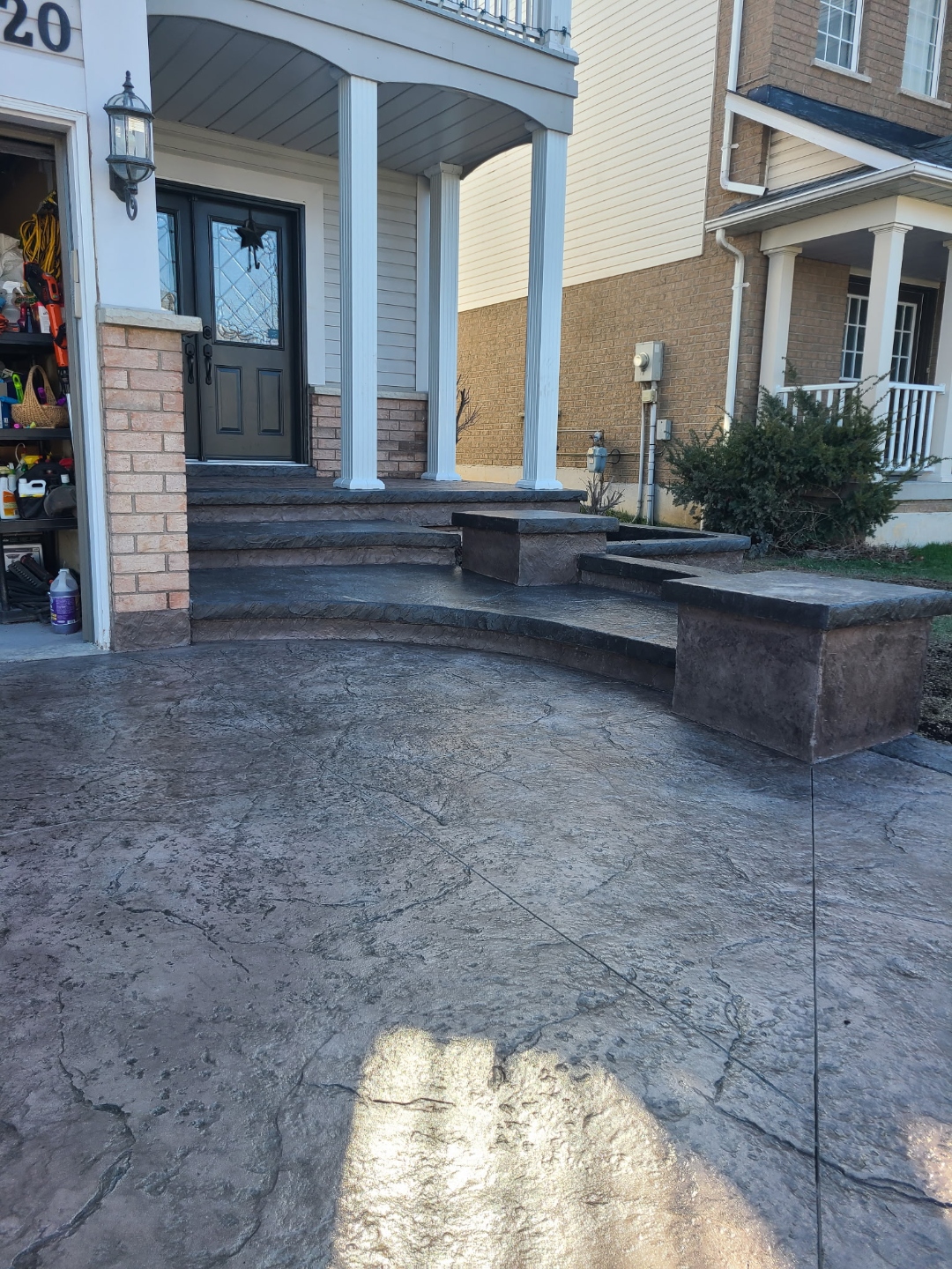 Dark stamped driveway with curved front stairs