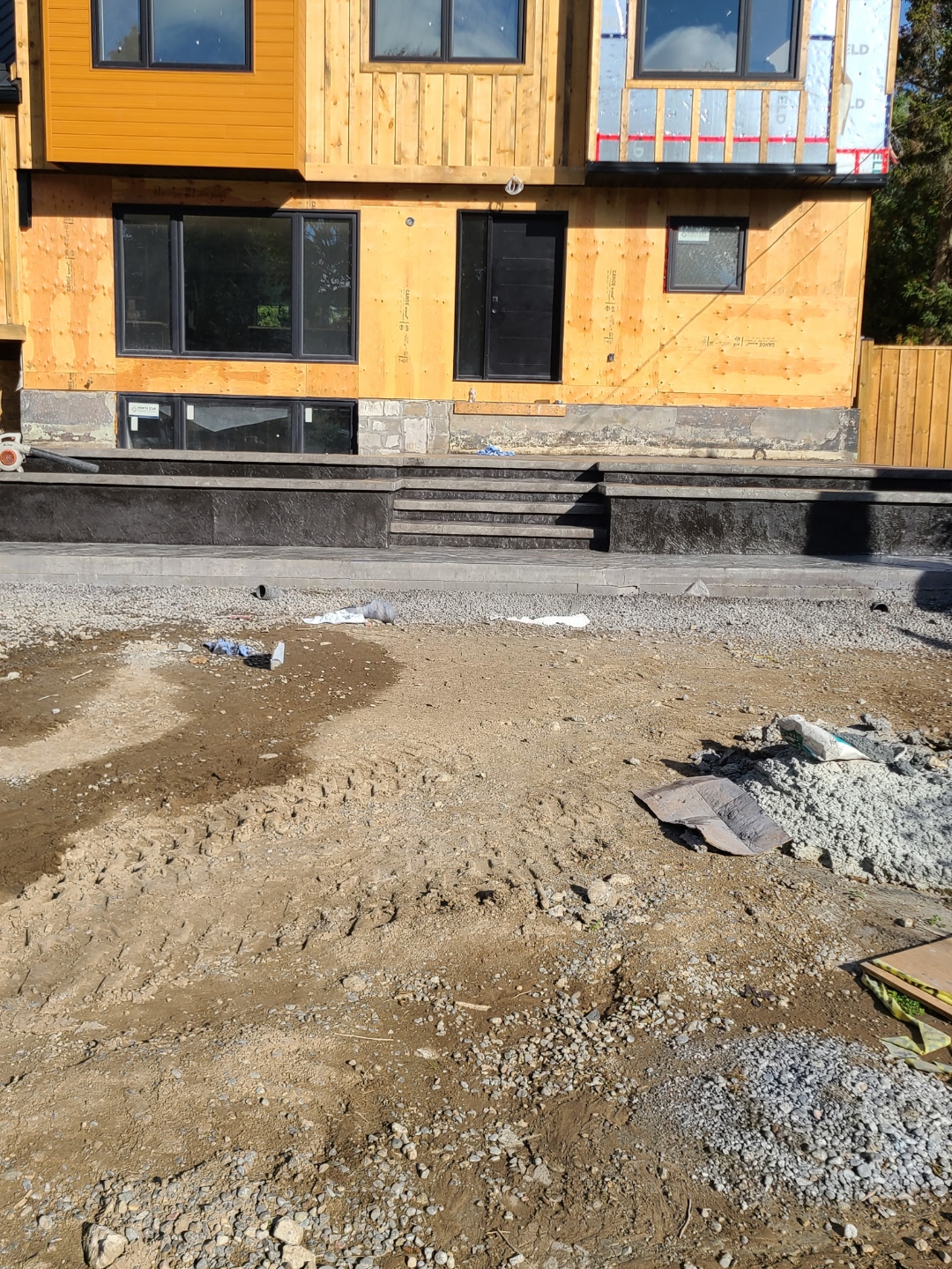 Stamped stairs in progress on modern home, no driveway yet