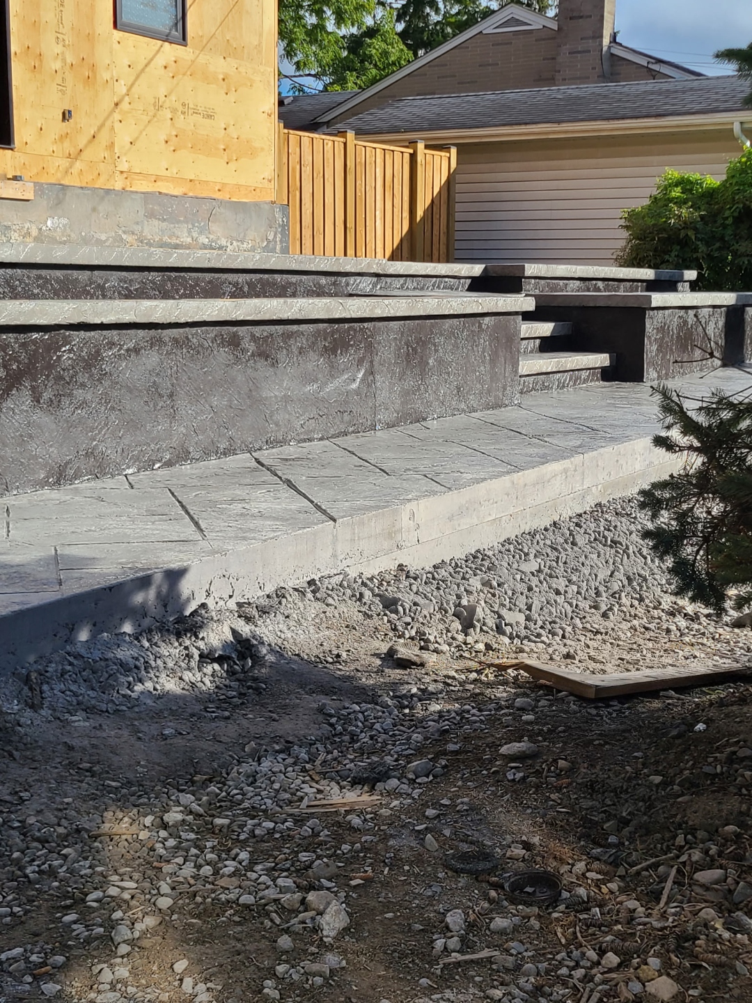 Grey stamped steps and patio landing on new construction