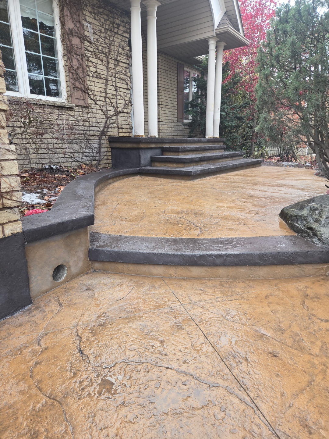 Stamped concrete front entry steps and walkway in tan and charcoal