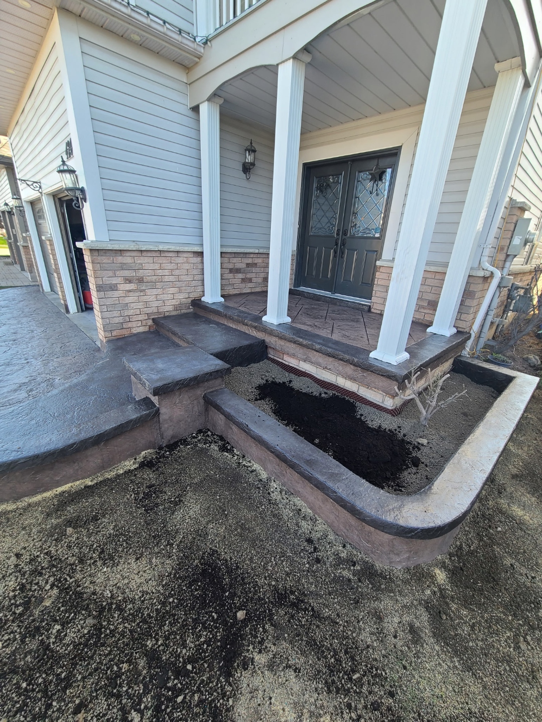 Stamped concrete front stairs with planter curb