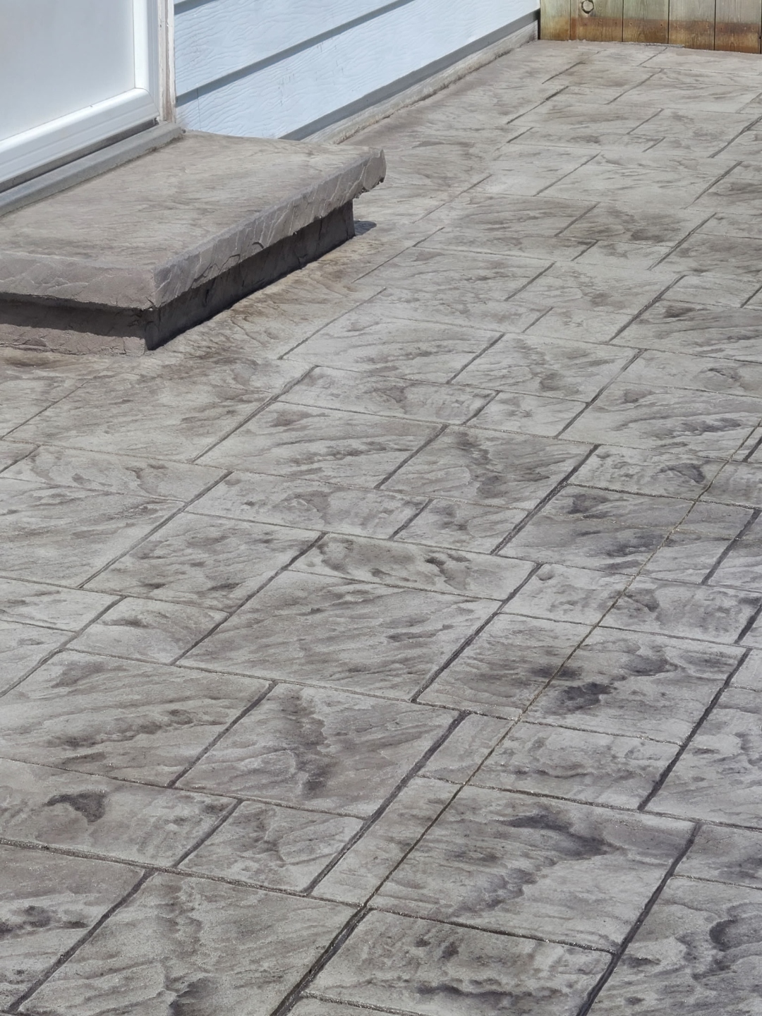 Grey stamped tile concrete porch closeup
