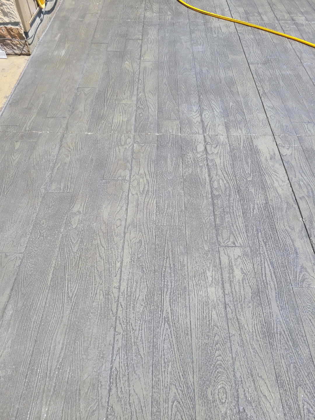 Wood grain stamped concrete surface