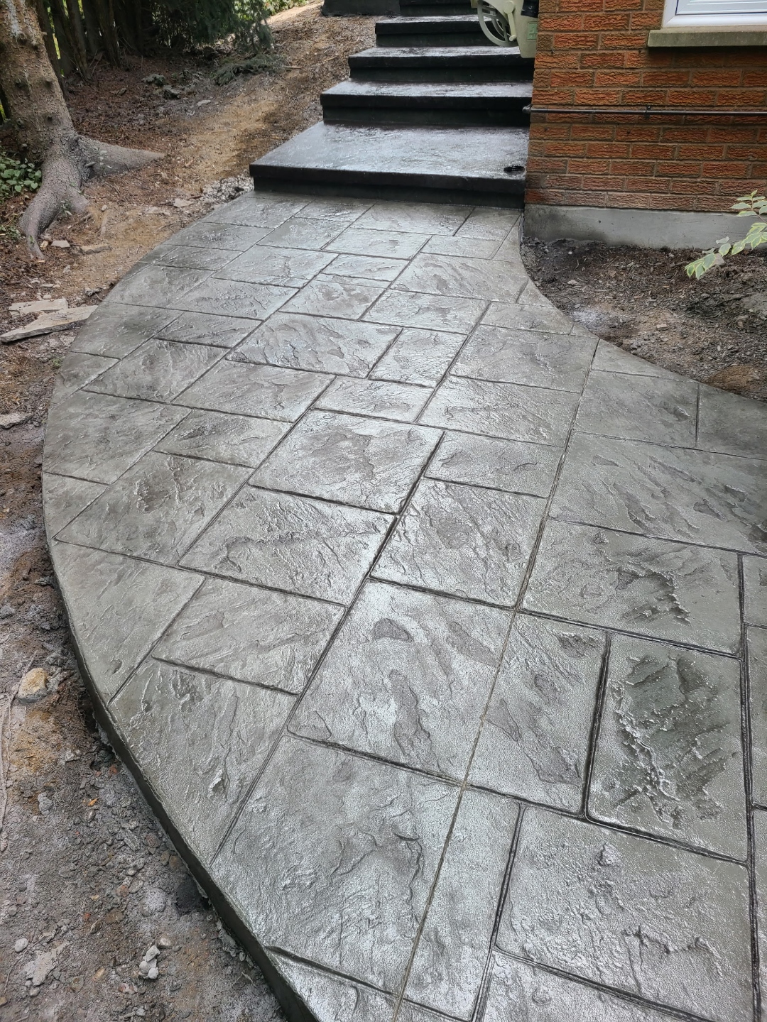 Curved stamped walkway leading to front stairs